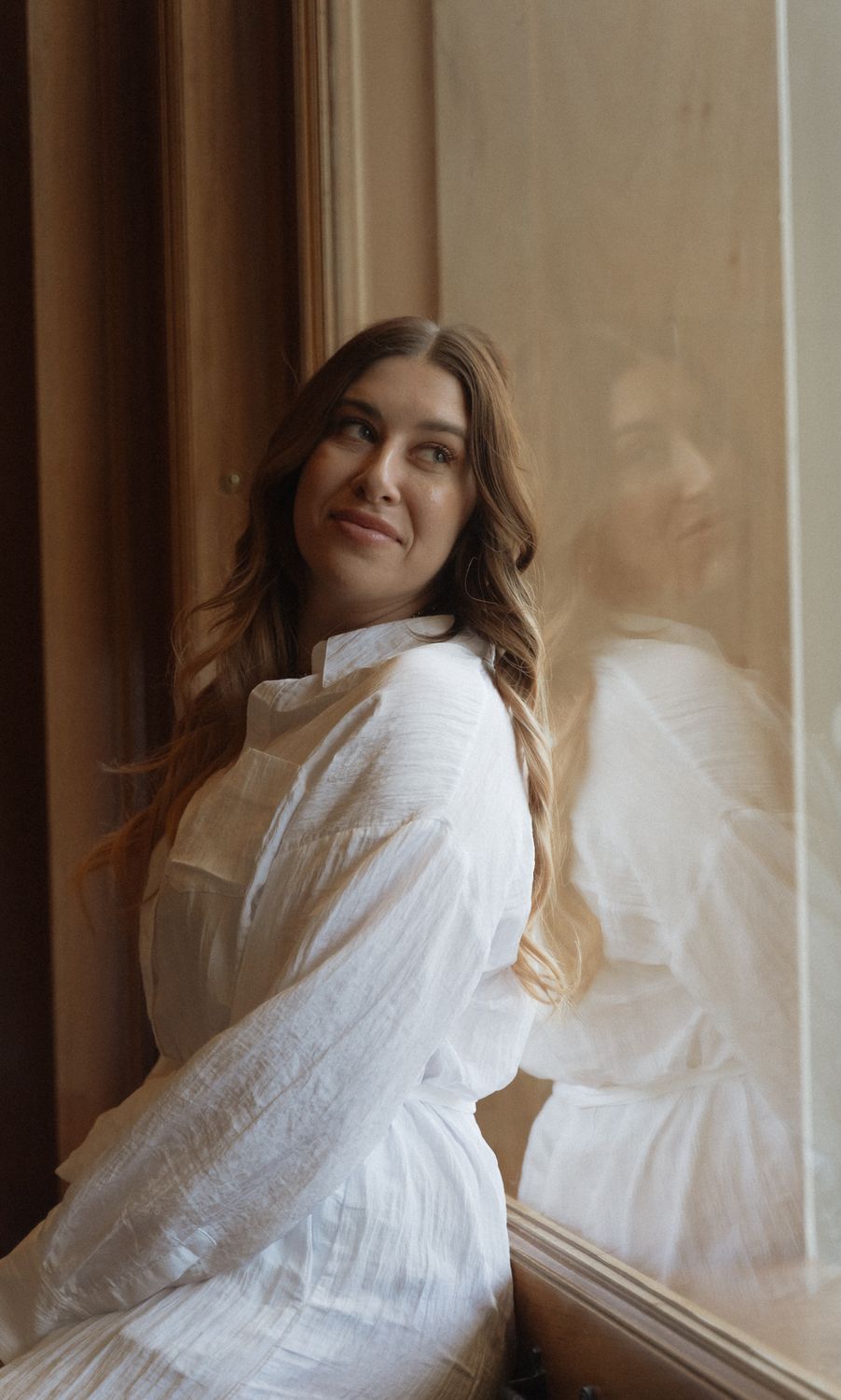 Crown Point Vaginal Rejuvenation model in a white tank top looking up