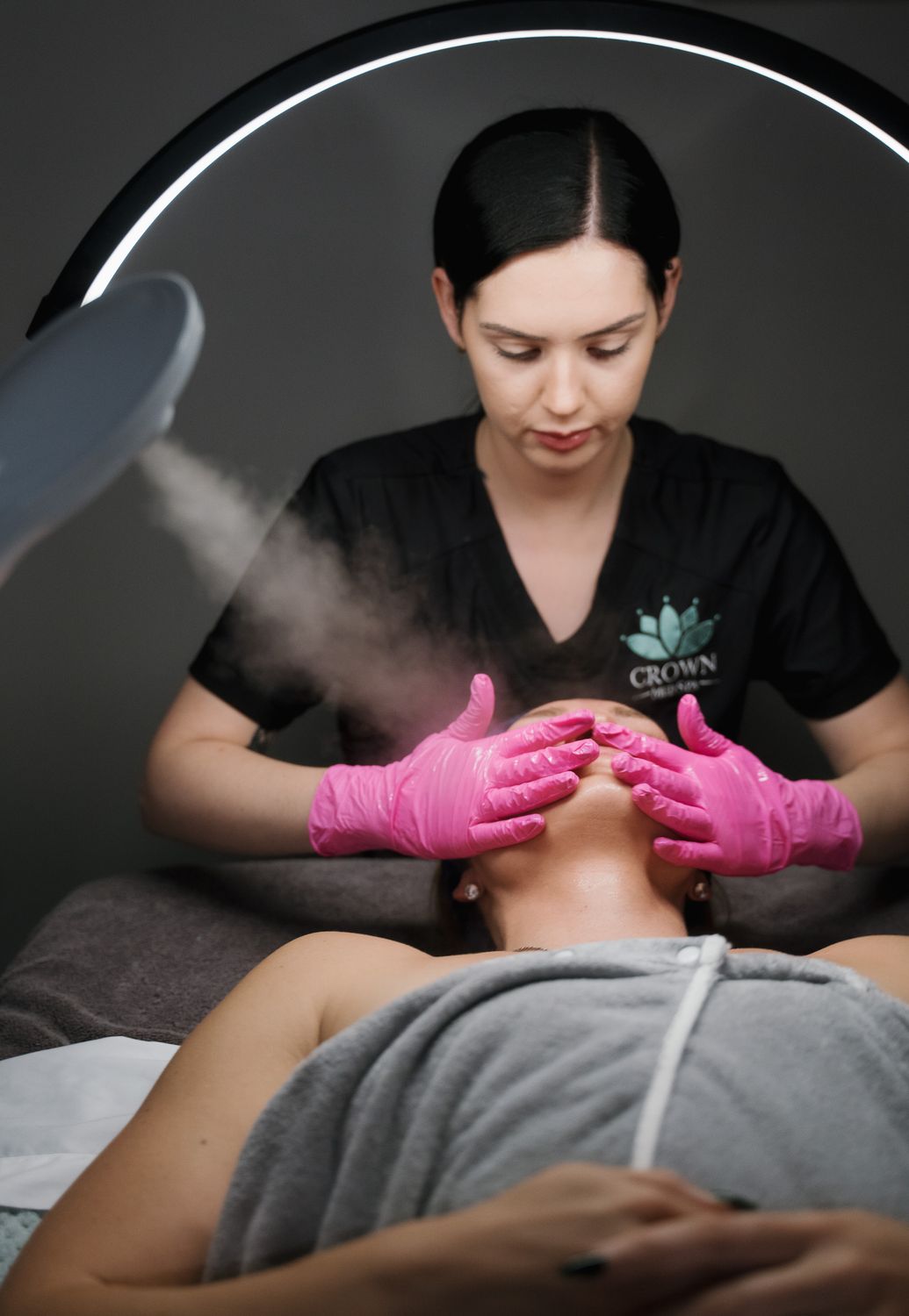 Crown Point Facial model wearing a towel smiling