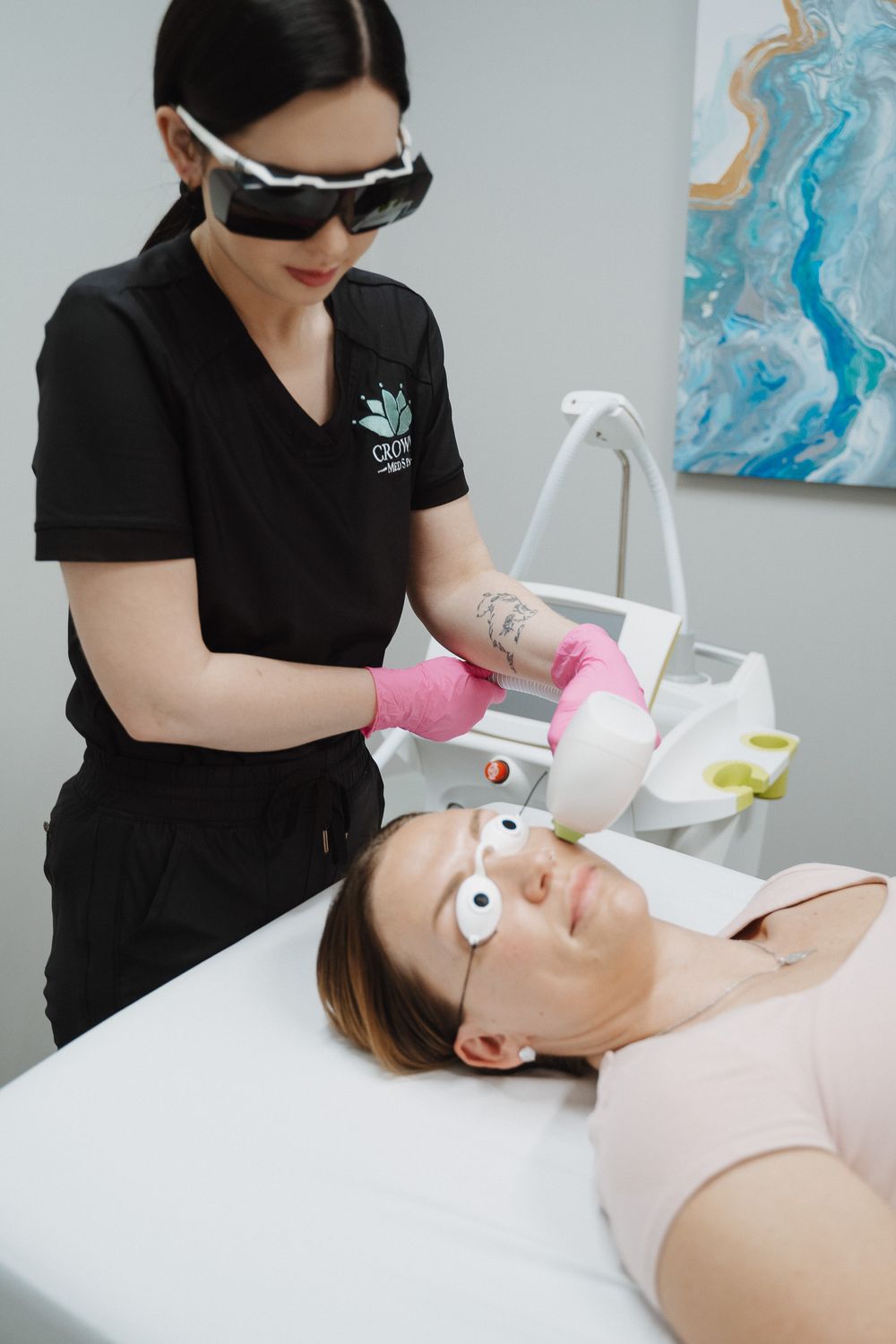 Crown Point Photofacial model with long dark hair wearing a white tank top