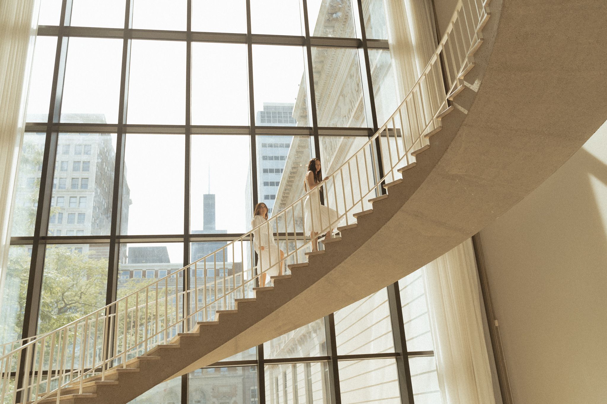 Shot model in white walking up a staircase